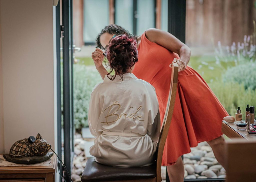 wedding prep, high tumbling bun hair style and bridal makeup by Pam Wrigley hair and makeup contact