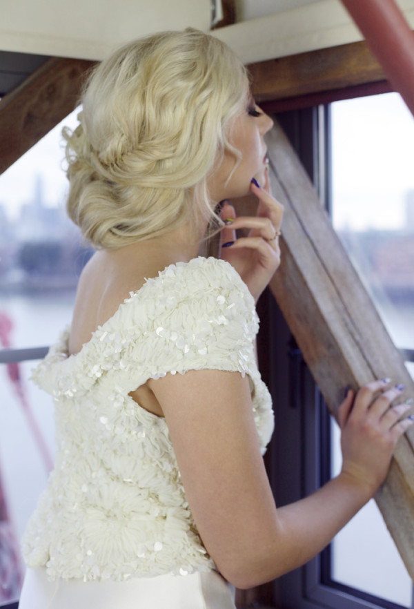 Soft relaxed, braided low bun hairstyle for a bride. Created by Pam Wrigley bridal hairstylist and wedding makeup artist, London.