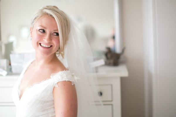 Beautiful natural bridal makeup and hair for the bride by Pam Wrigley. Plus low bun hairstyle wedding hairstyle for long hair by wedding makeup artist and bridal hair stylist in London.