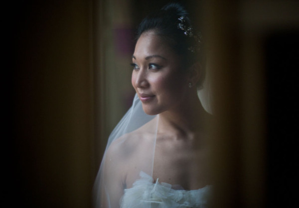 Wedding natural makeup and bridal hair in a high bun hairstyle for an Asian, Chinese bride. By Pam Wrigley wedding makeup artist and bridal hair stylist, London.