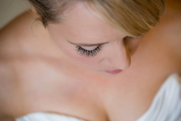 Wedding natural makeup with individual lashes, and bridal hair in a low bun hairstyle for a bride. By Pam Wrigley wedding makeup artist and bridal hair stylist, London.