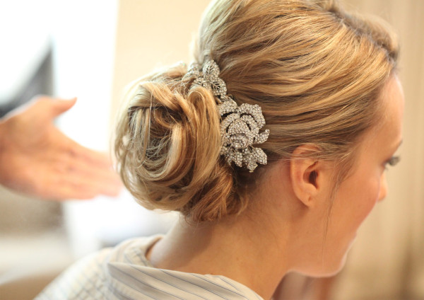 Wedding natural makeup and bridal hair in a soft low bun hairstyle for bride with soft curls. By Pam Wrigley wedding makeup artist and bridal hair stylist, London.