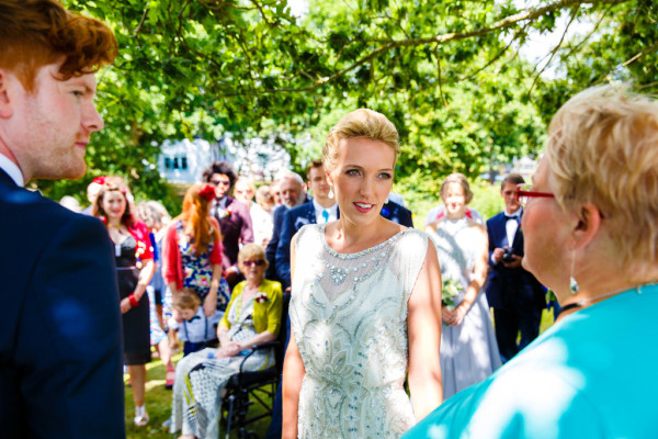 Natural bridal makeup and braided, bridal low bun hairstyles for brides with medium length hair. Plus makeup by wedding makeup artist and bridal hair stylist Pam Wrigley in Sussex