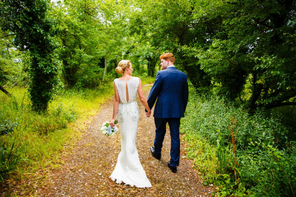 Natural bridal makeup and braided, bridal low bun hairstyles for brides with long hair. Plus makeup by wedding makeup artist and bridal hair stylist Pam Wrigley in Sussex